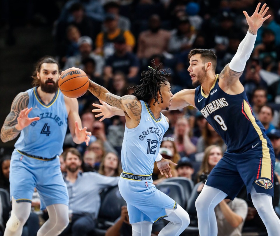 <strong>Memphis Grizzlies guard Ja Morant (middle) fakes a pass against New Orleans Pelicans defender Willy Hernangomez (right) during action on Saturday, April 9, 2022.</strong> (Mark Weber/The Daily Memphian)