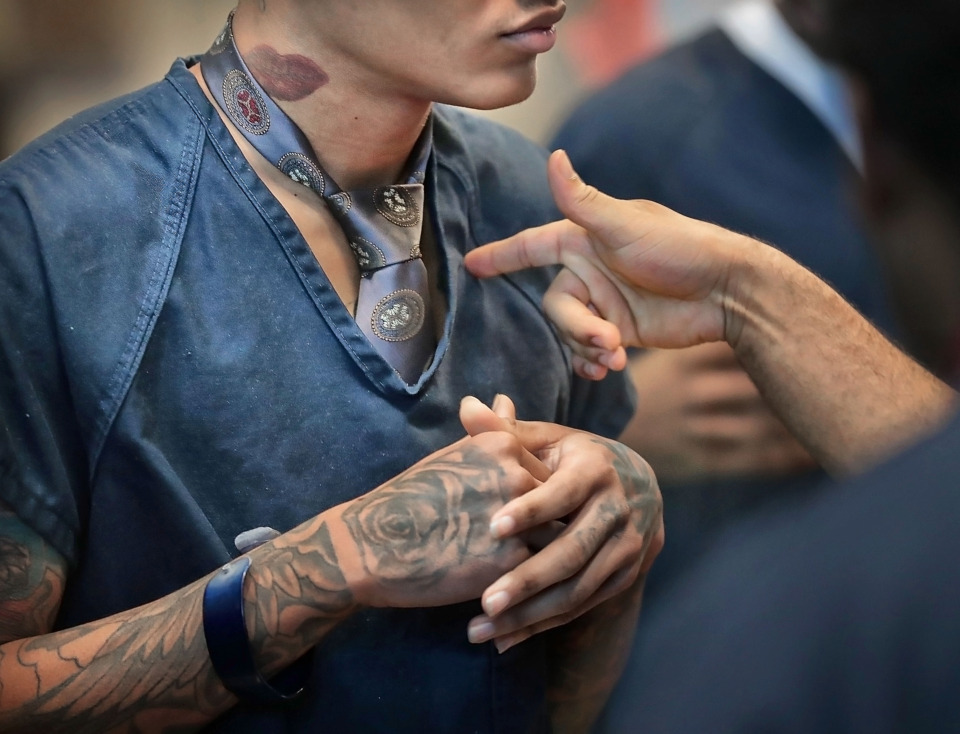 <strong>Inmates dress for success, adding ties to their uniforms on March 14, 2019, during a "Business Bonanza" at the Shelby County Jail. Prisoners had the opportunity to pitch their entrepreneurial ideas for a group of community leaders, visiting students and law enforcement officials in an effort to help them develop their dreams before they are released.</strong> (Jim Weber/Daily Memphian)