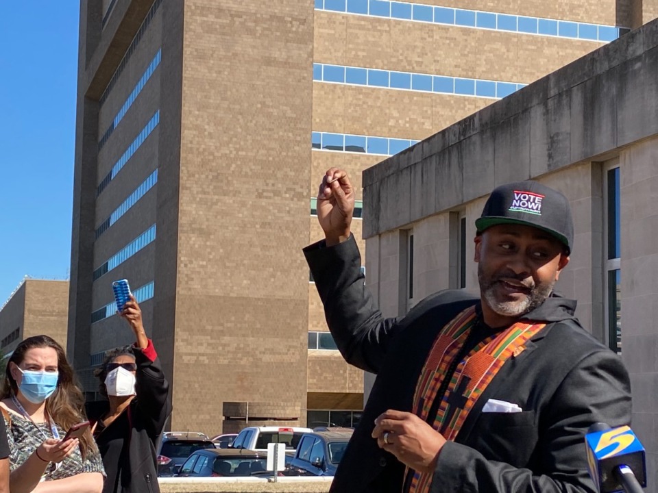 <strong>Rev. Earle Fisher leads a group in communion outside the Shelby County Election Commission&rsquo;s early-voting site as part of a&nbsp;&ldquo;Black-Out&rdquo; protest over limiting the first two days of early voting to just the Downtown site.</strong> (Bill Dries/Daily Memphian)
