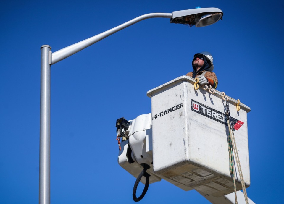 <strong>A worker with Northcentral Electric inspects an LED street light in Olive Branch, Mississippi. Collierville is also considering LED lights.</strong> (Patrick Lantrip/Daily Memphian)