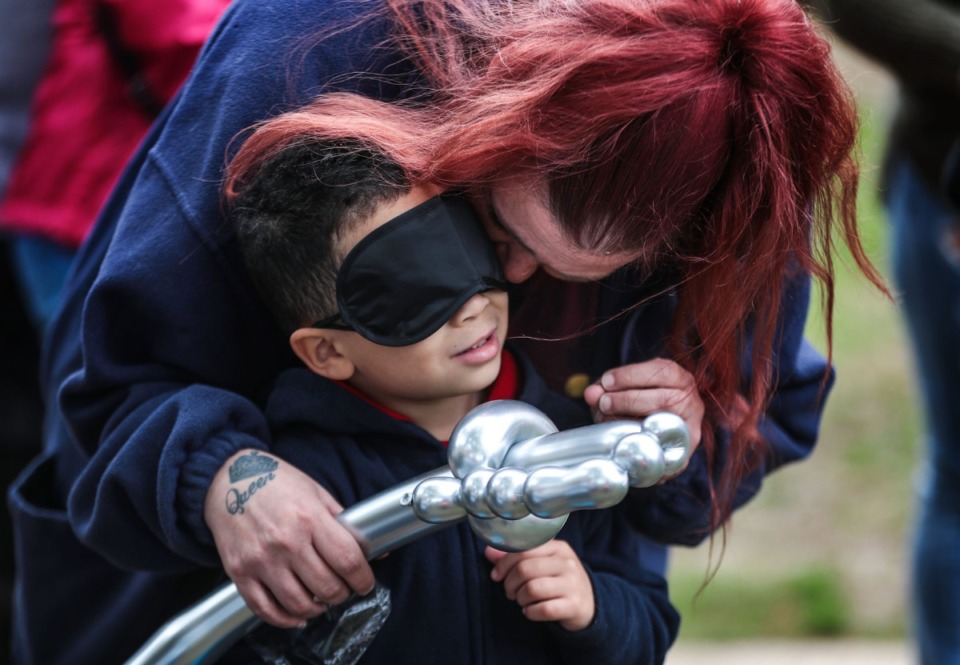 <strong>Amanda Bryant helps her grandson, Kylen Bryant, put on a facemask provided for children with sight who wanted participate in a beeping Easter egg hunt for visually impaired children and adults.</strong> (Patrick Lantrip/Daily Memphian)