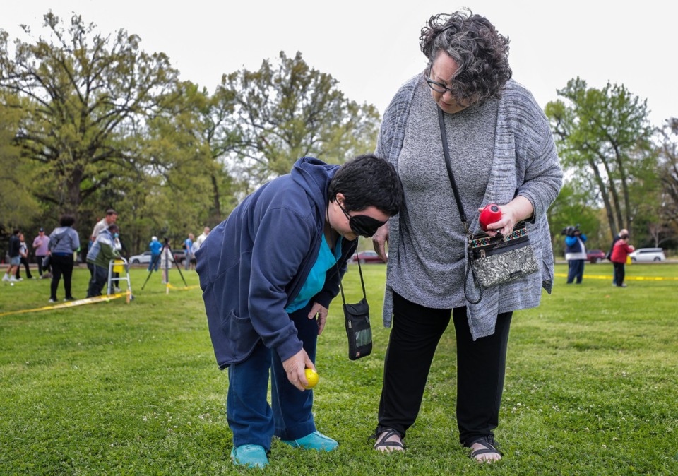 <strong>Beryl Wight (right) helps her sister, Wendy Wight, during an Easter egg at Overton Park.</strong> (Patrick Lantrip/Daily Memphian)