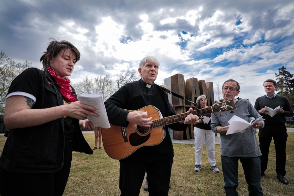 <strong>Father Bruce Nieli plays guitar at I AM A MAN Plaza during St. Patrick's Catholic Church Good Friday Stations of the Cross procession through Downtown.</strong> (Patrick Lantrip/Daily Memphian)