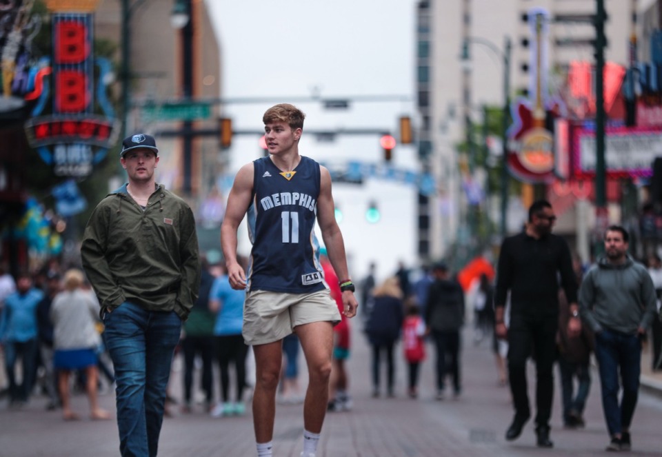 <strong>Zachary Doyle (left) and Lawrence Uhl walk down Beale Street Saturday before the Memphis Grizzlies&rsquo; first playoff game of the 2022 season.</strong> (Patrick Lantrip/Daily Memphian)