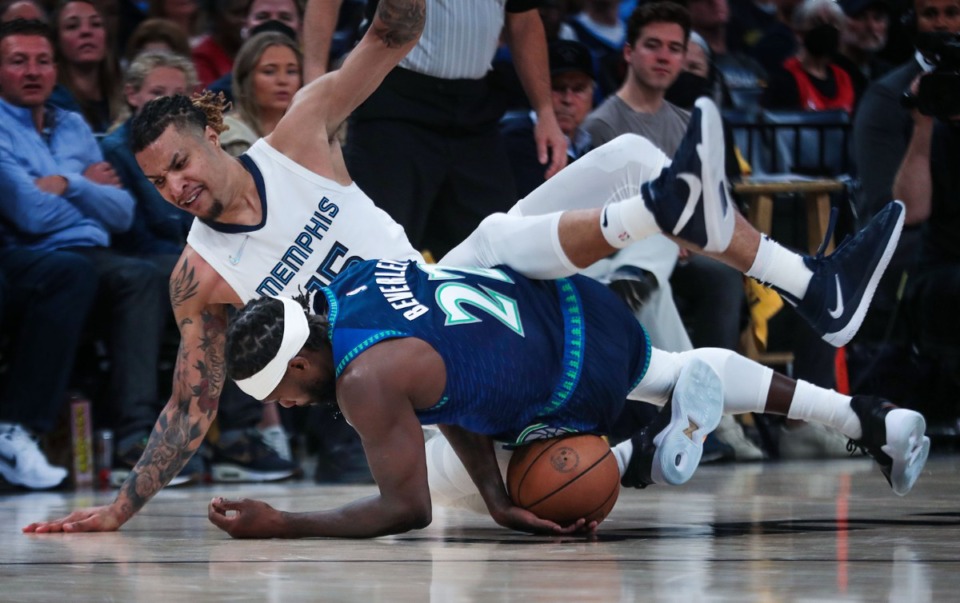 <strong>Memphis Grizzlies forward Brandon Clarke (15) trips over a diving Patrick Beverly (22) during the Saturday playoff game against the Minnesota Timberwolves.</strong> (Patrick Lantrip/Daily Memphian)