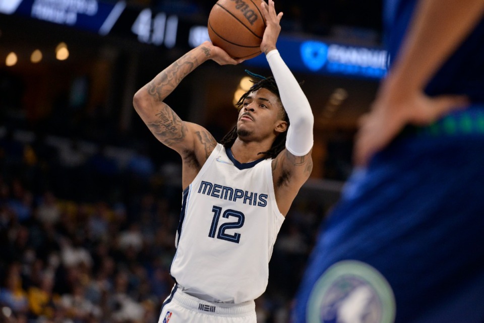 <strong>Memphis Grizzlies guard Ja Morant (12) shoots the ball in the first half during Game 1 of a first-round NBA basketball playoff series against the Minnesota Timberwolves Saturday, April 16, 2022, in Memphis, Tennessee.</strong> (AP Photo/Brandon Dill)