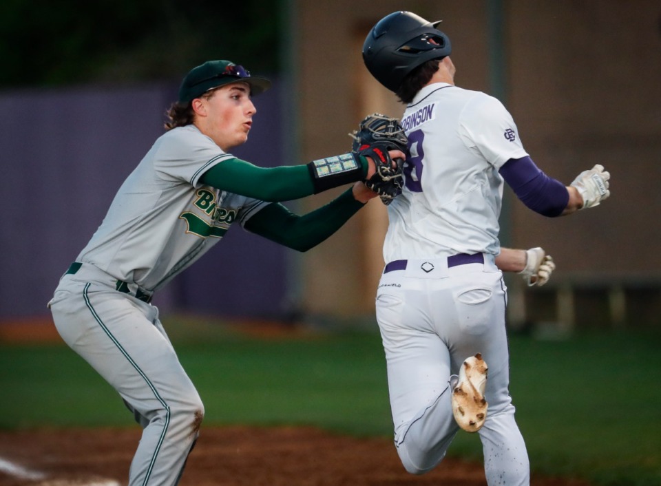 <strong>Briarcrest first basemen Jack Newman (left) tags out CBHS runner Holden Robinson (right) on April 18.</strong> (Mark Weber/The Daily Memphian)