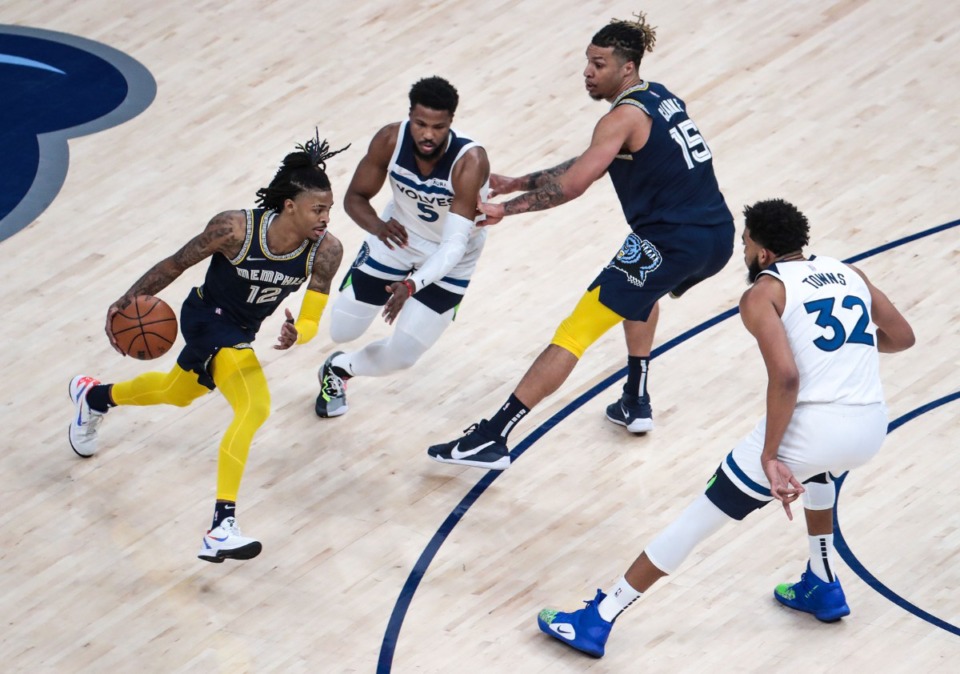 <strong>Grizzlies guard Ja Morant (12) brings the ball upcourt against a swarm of Timberwolves in Game 2 of the playoff series against Minnesota on April 19 at FedExForum.</strong> (Patrick Lantrip/Daily Memphian)