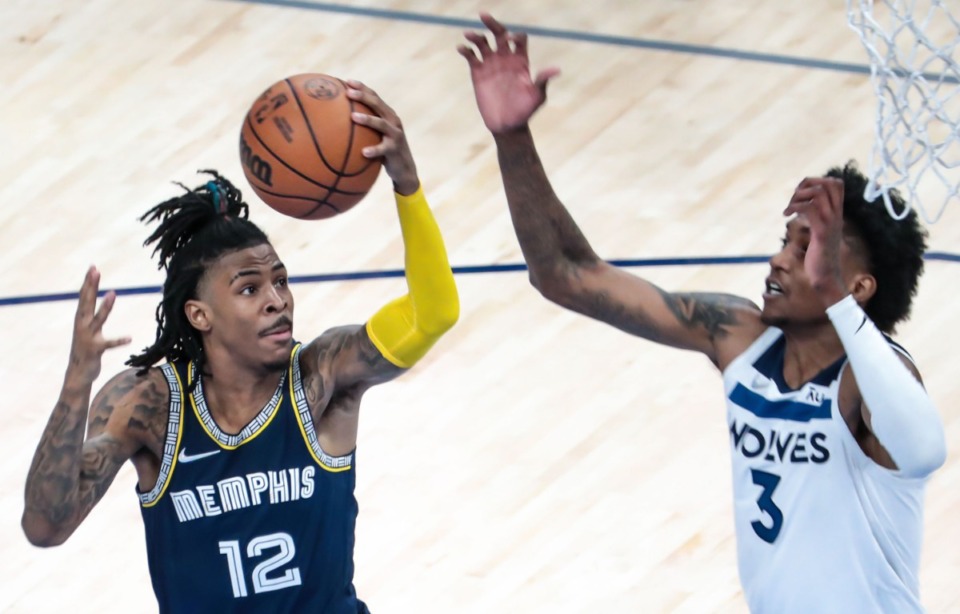 <strong>Grizzlies guard Ja Morant (12) goes for a layup in Game 2 of the playoff series against the Minnesota Timberwolves on April 19 at FedExForum.</strong> (Patrick Lantrip/Daily Memphian)