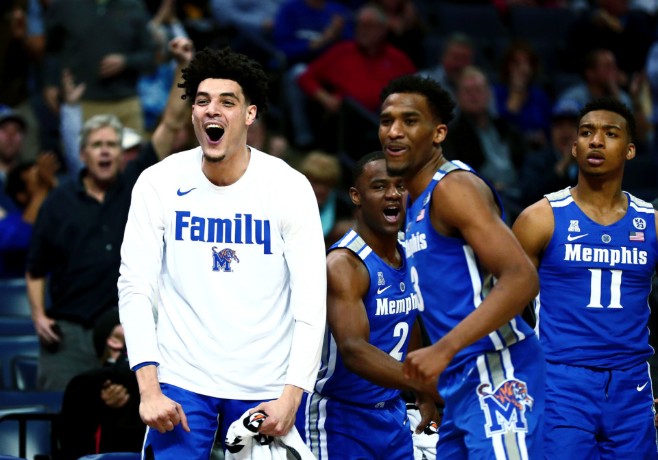 <strong>University of Memphis forward Isaiah Maurice (14), guard Jeremiah Martin (3) and guard Antwann Jones (11) celebrate after the Tigers drain a 3-point shot&nbsp;<span class="s1">during an AAC tournament game against UCF on Friday, March 15, 2019, at FedExForum in Memphis. (Houston Cofield/Daily Memphian)</span></strong>