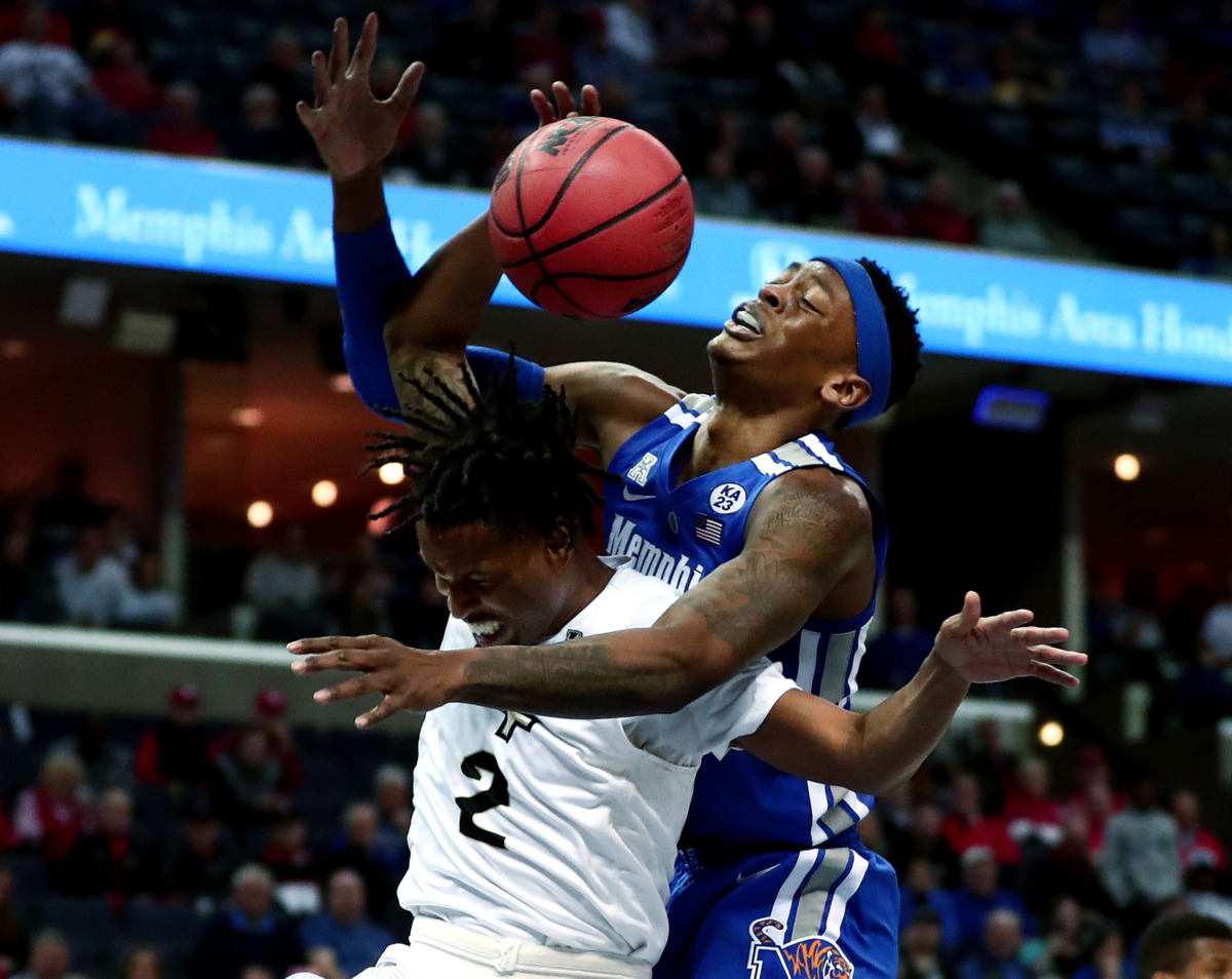 <strong>University of Memphis forward Kyvon Davenport (0) reaches for a rebound against University of Central Florida guard Terrell Allen (2)&nbsp;</strong><span class="s1"><strong>during an AAC tournament game against UCF on Friday, March 15, 2019, at FedExForum in Memphis. </strong>(Houston Cofield/Daily Memphian)</span>