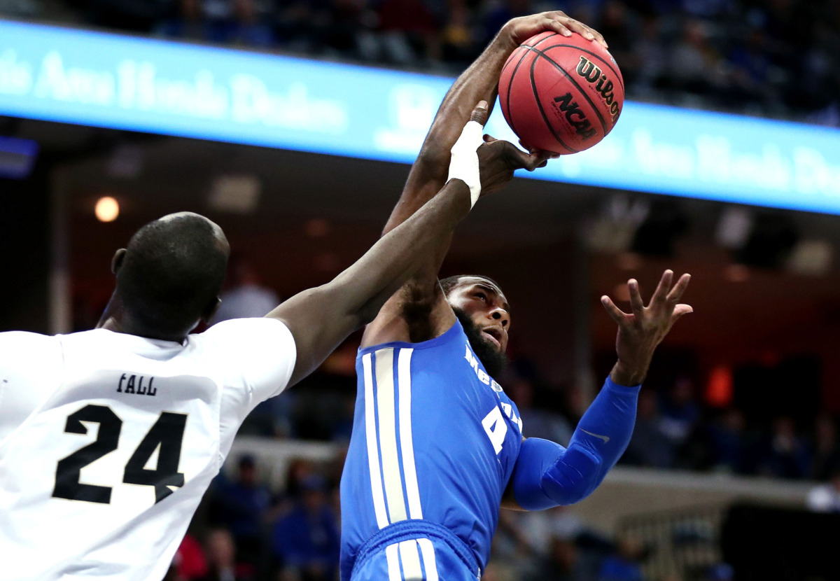<strong>University of Memphis forward Raynere Thornton (4) pulls down a rebound against University of Central Florida center Tacko Fall (24)&nbsp;</strong><span class="s1"><strong>during an AAC tournament game against UCF on Friday, March 15, 2019, at FedExForum in Memphis. </strong>(Houston Cofield/Daily Memphian)</span>