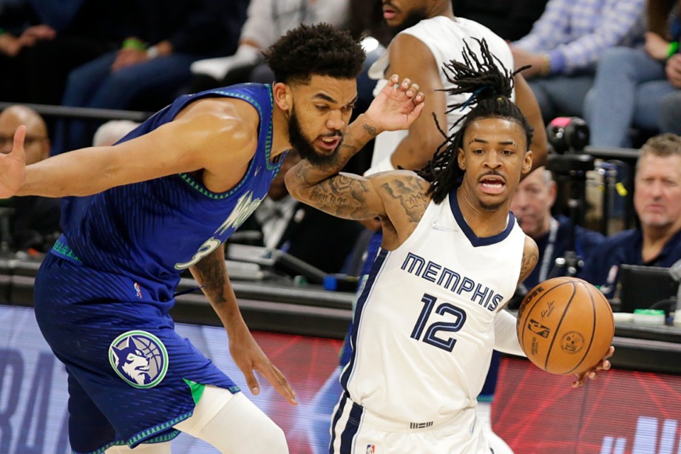 <strong>Grizzlies guard Ja Morant (12) drives on Minnesota Timberwolves center Karl-Anthony Towns (32) in Game 3 of Round 1 of the 2022 NBA playoffs on&nbsp; April 21, 2022, in Minneapolis.</strong> (Andy Clayton-King/AP)