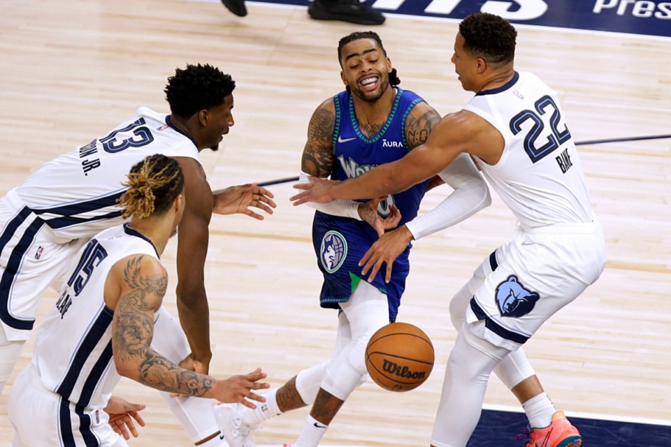 <strong>Minnesota Timberwolves guard D'Angelo Russell (0) meets defense from Memphis Grizzlies' Desmond Bane (22), Jaren Jackson Jr. (13) and Brandon Clarke (15) on April 21, 2022, in Minneapolis.</strong> (Andy Clayton-King/AP)