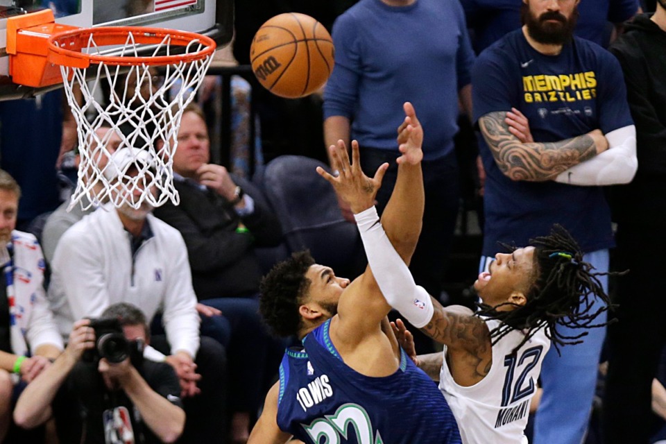 <strong>Memphis Grizzlies guard Ja Morant (12) shoots against Minnesota Timberwolves center Karl-Anthony Towns (32) on April 21, 2022, in Minneapolis.</strong> (Andy Clayton-King/AP)