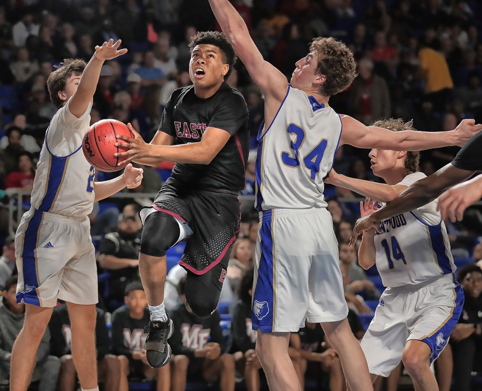 <strong>East's Derrein Merriweather shoots under pressure by Brentwood's Ben Mills (34) during East High School's TSSAA Class AAA semifinal game against Brentwood at MTSU in Murfreesboro on March 15, 2019.</strong> (Jim Weber/Daily Memphian)