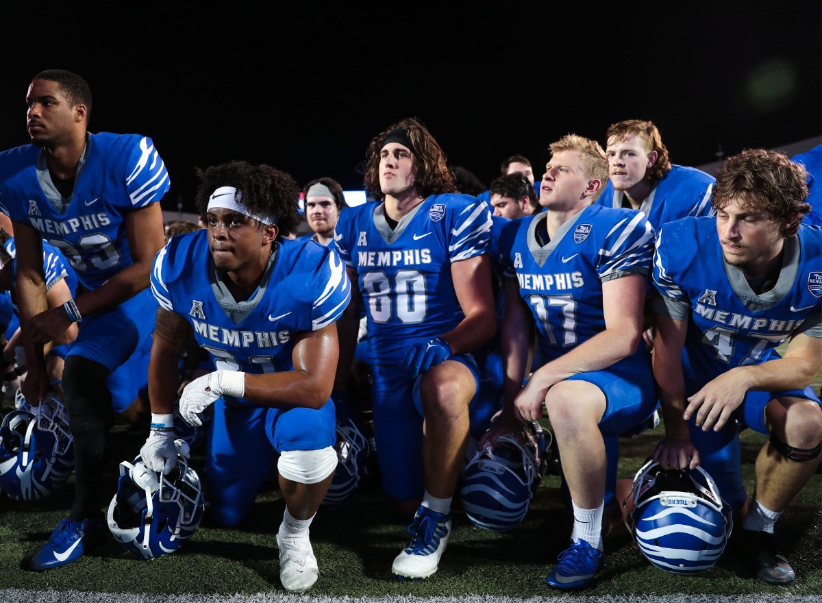 <strong>University of Memphis Tigers kneel while listening to their coach speak after the Tigers&rsquo; spring game on April 22, 2022.</strong> (Patrick Lantrip/Daily Memphian)
