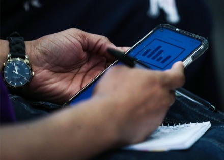 <strong>Attendees used their phones to vote for the candidates speaking at the People's Convention 2022, Saturday at the National Civil Rights Museum.</strong> (Patrick Lantrip/Daily Memphian)