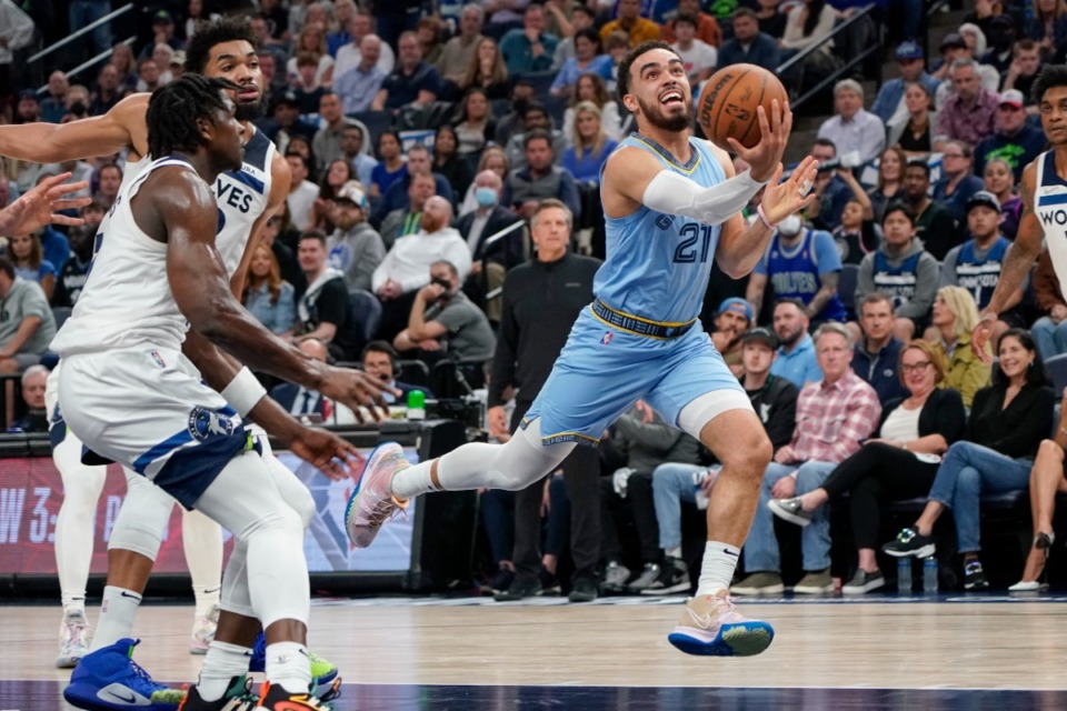 <strong>Memphis Grizzlies guard Tyus Jones, right, drives past Minnesota Timberwolves guard Anthony Edwards, front left, and center Karl-Anthony Towns during the first half in Game 4 of an NBA basketball first-round playoff series Saturday, April 23, 2022, in Minneapolis.</strong> (AP Photo/Craig Lassig)
