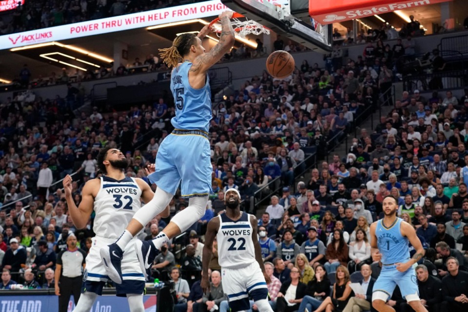<strong>Memphis Grizzlies forward Brandon Clarke dunks as Minnesota Timberwolves center Karl-Anthony Towns, (32) and guard Patrick Beverley (22) and Grizzlies forward Kyle Anderson (1) watch during the first half of Game 4 of an NBA basketball first-round playoff series Saturday, April 23, 2022, in Minneapolis</strong>. (AP Photo/Craig Lassig)