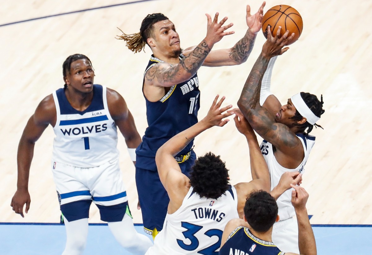 <strong>Memphis Grizzlies forward Brandon Clarke (middle) reaches for a rebound against Minnesota</strong>&nbsp;<strong>on Tuesday, April 26, 2022, at FedExForum.</strong> (Mark Weber/The Daily Memphian)