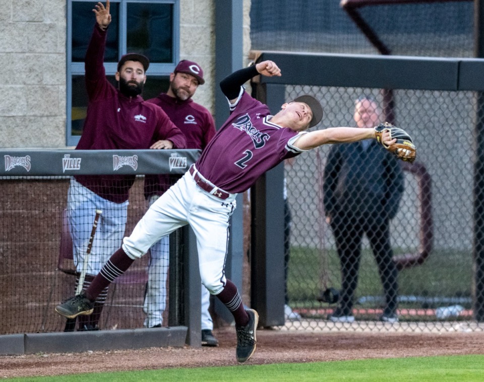 <strong>Collierville High School third baseman Joey Caruso stretches to make a play in foul territory against Houston High School at Collierville on Tuesday, April 26, 2022.</strong> (Greg Campbell/Special to The Daily Memphian).