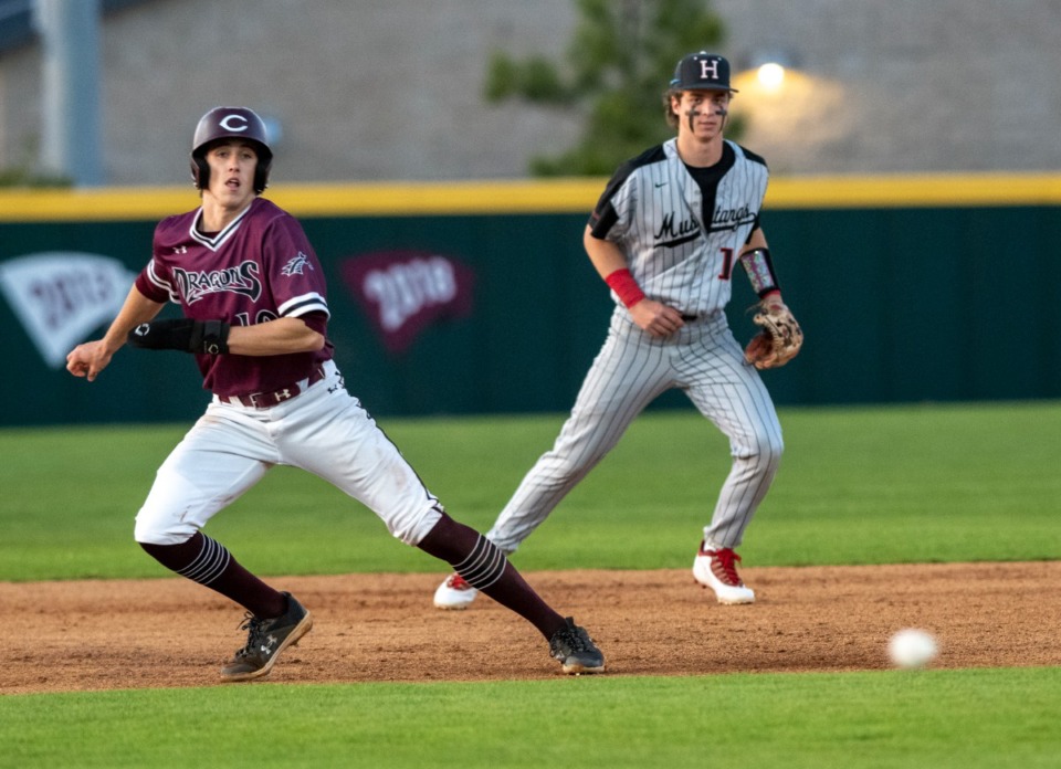 <strong>Collierville High School's Grayson Saunier advances to third base as Houston shortstop Tyler Yearwood reacts to a ground ball at Collierville High School on Tuesday, April 26, 2022.</strong> (Greg Campbell/Special to The Daily Memphian).