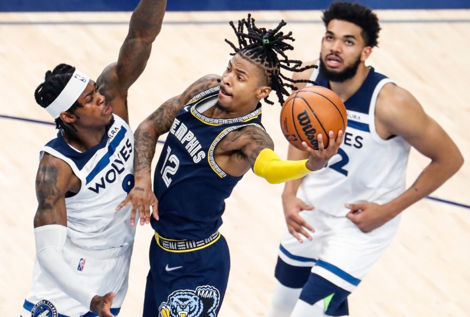 <strong>Memphis Grizzlies guard Ja Morant (middle) drives the lane against Minnesota&rsquo;s Jarred Vanderbilt (left) and Karl-Anthony Towns (right) on Tuesday, April 26, 2022.</strong> (Mark Weber/The Daily Memphian)