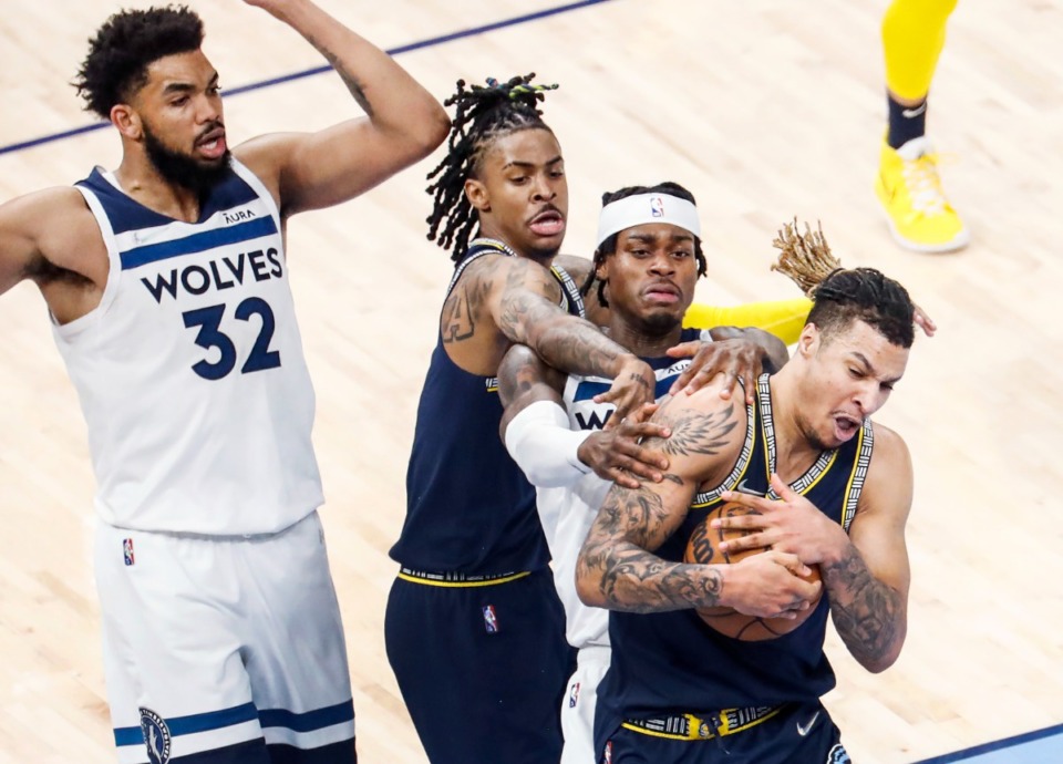 <strong>Memphis Grizzlies forward Brandon Clarke (right) and guard Ja Morant (middle left) battle Minnesota&rsquo;s Jarred Vanderbilt (middle) for a rebound on Tuesday, April 26, 2022.</strong> (Mark Weber/The Daily Memphian)