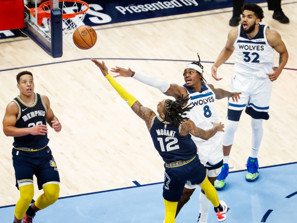 <strong>Memphis Grizzlies guard Ja Morant (bottom) hits the game-winning layup against Minnesota&rsquo;s Jarred Vanderbilt (right) on Tuesday, April 26, 2022.</strong> (Mark Weber/The Daily Memphian)