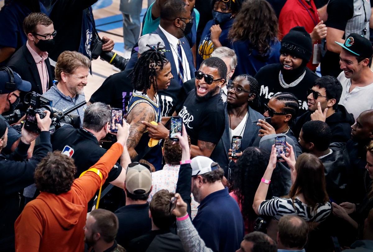 <strong>Memphis Grizzlies guard Ja Morant (left) celebrates with his father Tee Morant (right) after hitting the game-winning layup against the Minnesota Timberwolves on Tuesday, April 26, 2022.</strong> (Mark Weber/The Daily Memphian)