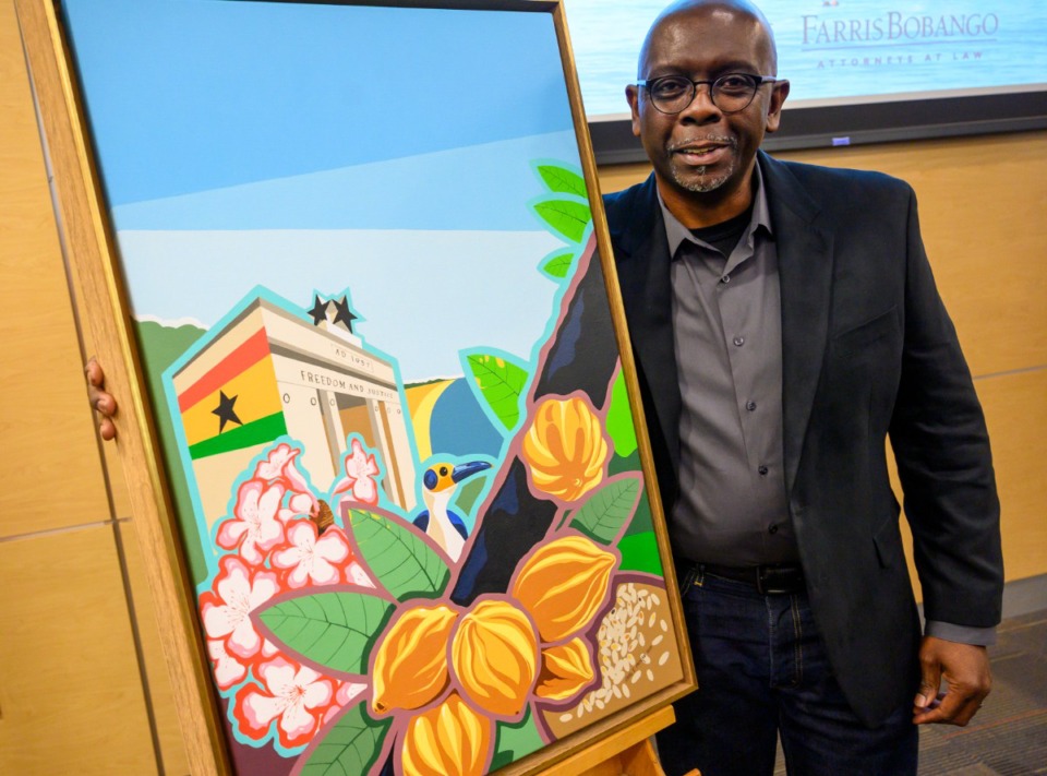 <strong>Carl Moore poses with his painting, which was chosen for the Memphis in May poster honoring Ghana on Feb. 4, 2020. Ghana was named the honored country in 2020, but all events were canceled because of COVID-19.</strong> (Greg Campbell/Special to The Daily Memphian file)