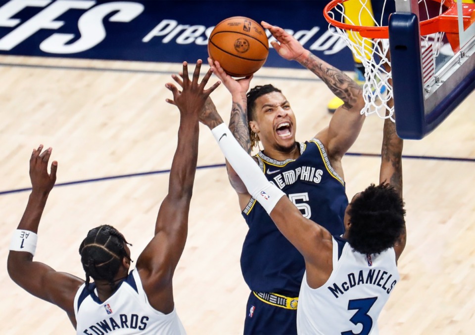 <strong>Memphis Grizzlies forward Brandon Clarke (top) drives to the basket against the Minnesota Timberwolves defense during action on Tuesday, April 26, 2022.</strong> (Mark Weber/The Daily Memphian)