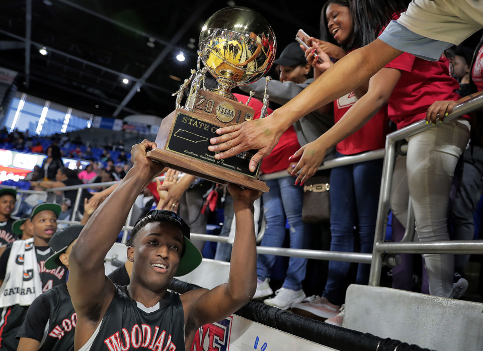 <strong>Wooddale's Alvin Miles parades the trophy by fans after Wooddale's TSSAA Class AA state basketball finals win over Knoxville Fulton at MTSU in Murfreesboro on March 16, 2019.</strong> (Jim Weber/Daily Memphian)