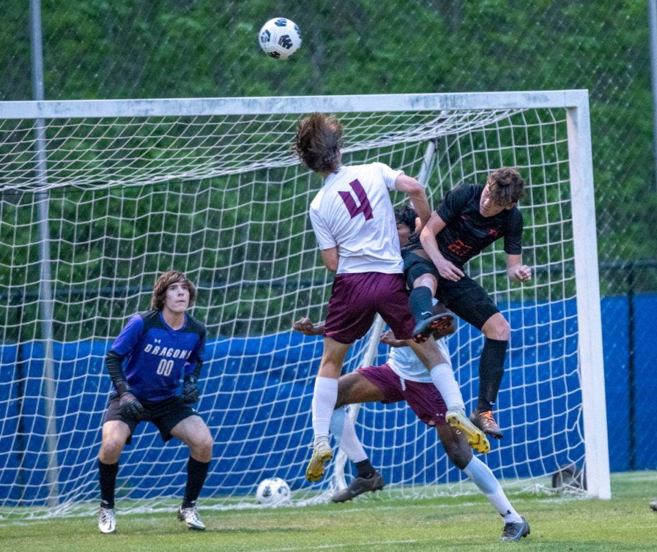 <strong>Collierville goalie Patrick Muran (00) watches the ball carefully as teammates Charlie Jones and Shiva Thiagrajan (32) defend a header by Bartlett's Toby Thomas on April 28, 2022.</strong> (Greg Campbell/Special to The Daily Memphian)