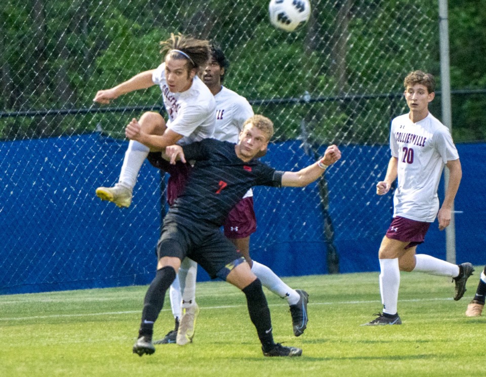 <strong>Collierville High's Charlie Jones (4) climbs over the back of Bartlett's Nathan Dimauro to block his header, avoiding a goal in the final seconds of the first period at Bartlett High School on Thursday, April 28, 2022.</strong> (Greg Campbell/Special to The Daily Memphian)
