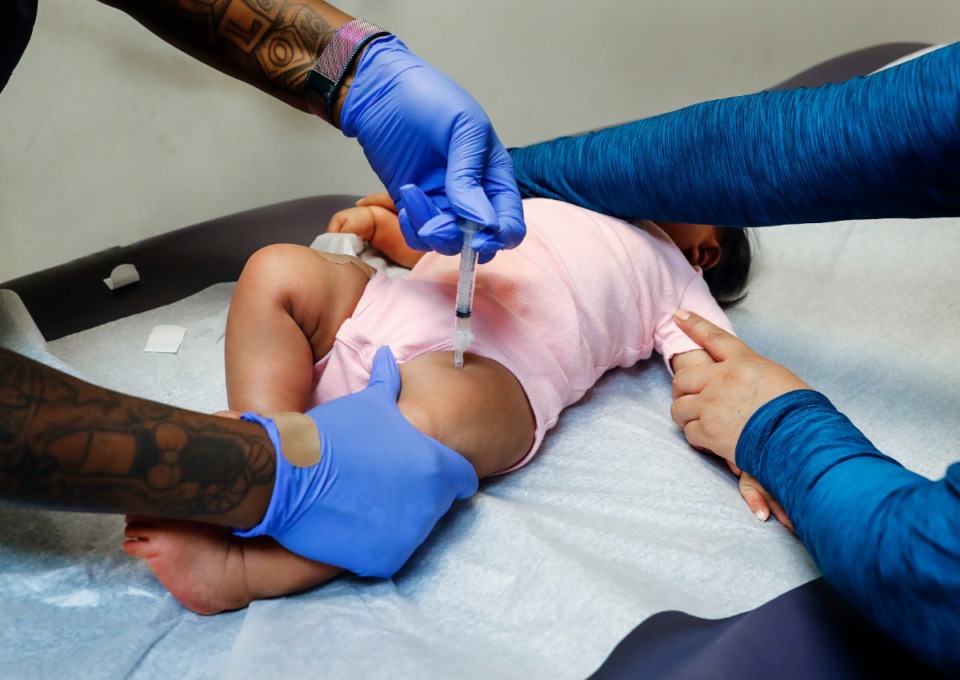 <strong>A shot nurse gives an immunization shot to a 6-month-old child at Christ Community Health Services in 2021.</strong>&nbsp;(Mark Weber/The Daily Memphian file)