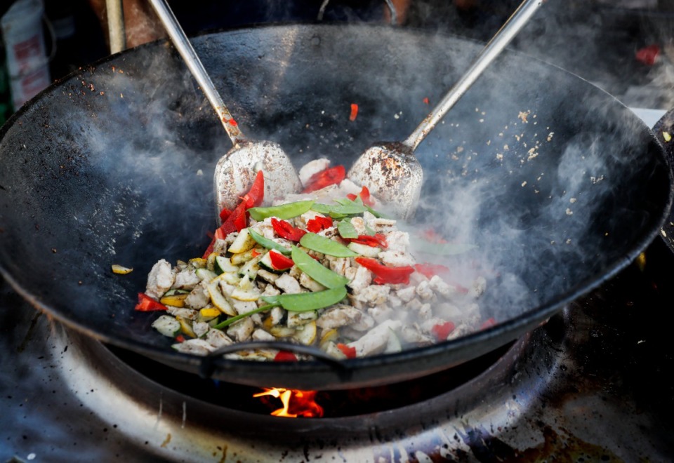 <strong>Stir fry is cooked up at Island Noodle during the first day of the Beale Street Music Festival on Friday, April 29, at Liberty Park.</strong> (Mark Weber/The Daily Memphian)