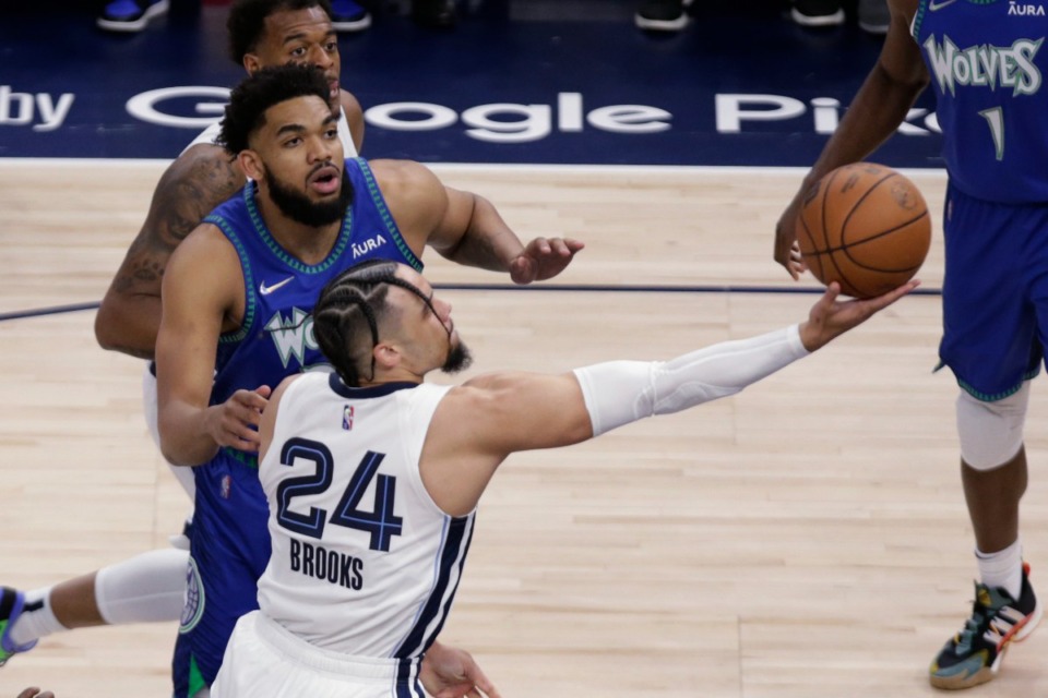 <strong>Memphis Grizzlies forward Dillon Brooks (24) shoots in front of Minnesota center Karl-Anthony Towns (32) in Game 6 of the first round of the NBA playoffs on Friday, April 29, 2022, in Minneapolis.</strong> (AP Photo/Andy Clayton-King)