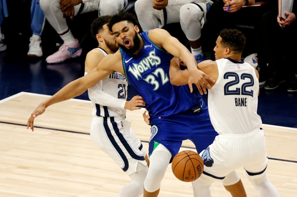 <strong>Minnesota center Karl-Anthony Towns (32) is fouled by Memphis Grizzlies guard Desmond Bane (22) with defensive help from Grizzlies guard Tyus Jones (21) on April 29, 2022, in Minneapolis.</strong> (Andy Clayton-King/AP)