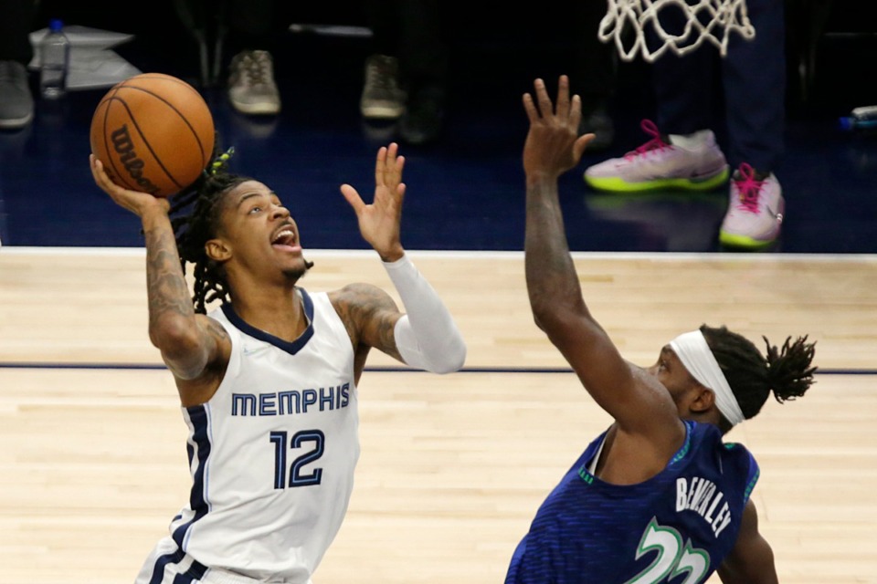 <strong>Memphis Grizzlies guard Ja Morant (12) shoots against Minnesota guard Patrick Beverley (22) on April 29, 2022, in Minneapolis.</strong> (Andy Clayton-King/AP)