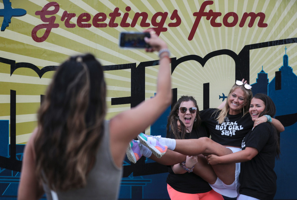 <strong>Eden Hernandez takes a photo of Alex Rawls (from left) Bre Brown and Kourtney Brown at Beale Street Music Fest at Liberty Park, April 30, 2022.</strong> (Patrick Lantrip/Daily Memphian)