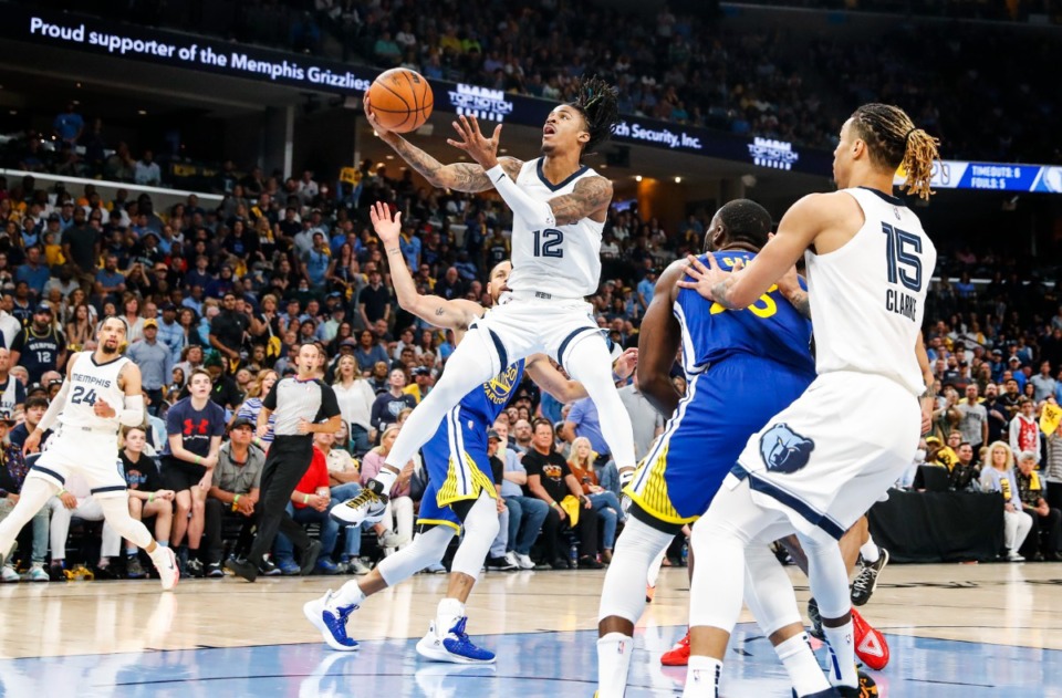 <strong>Memphis Grizzlies guard Ja Morant (middle) drives the lane against the Golden State Warriors defense on Sunday, May 1, 2022.</strong> (Mark Weber/The Daily Memphian)