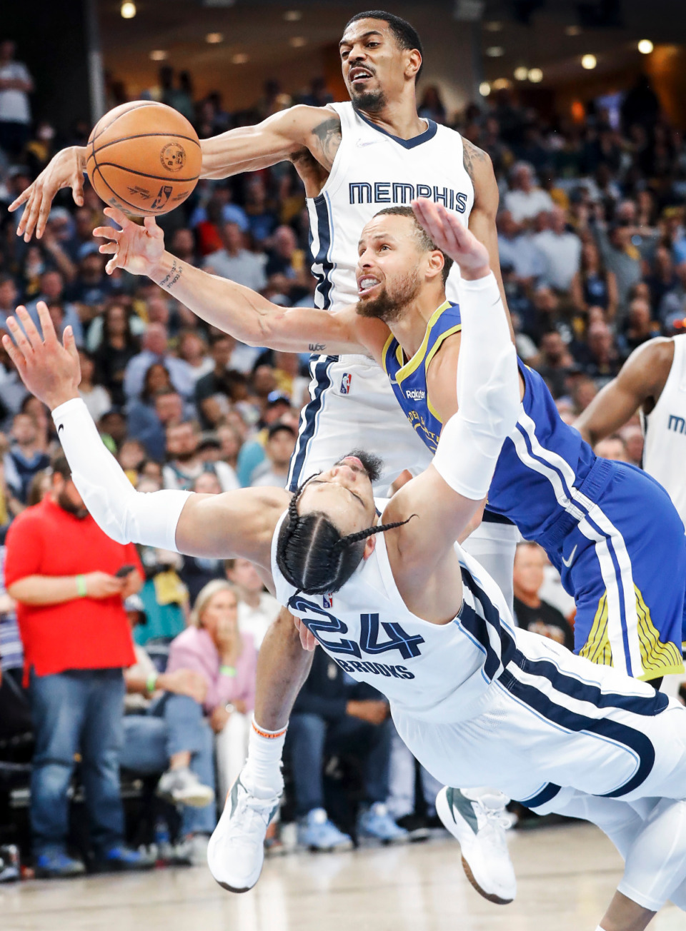 <strong>Golden State Warriors guard Stephen Curry (middle) is called for a foul after running into Memphis Grizzlies defender Dillon Brooks (bottom) as teammate De'Anthony Melton (top) helps defend on the play during action on Sunday, May 1, 2022.</strong> (Mark Weber/The Daily Memphian)