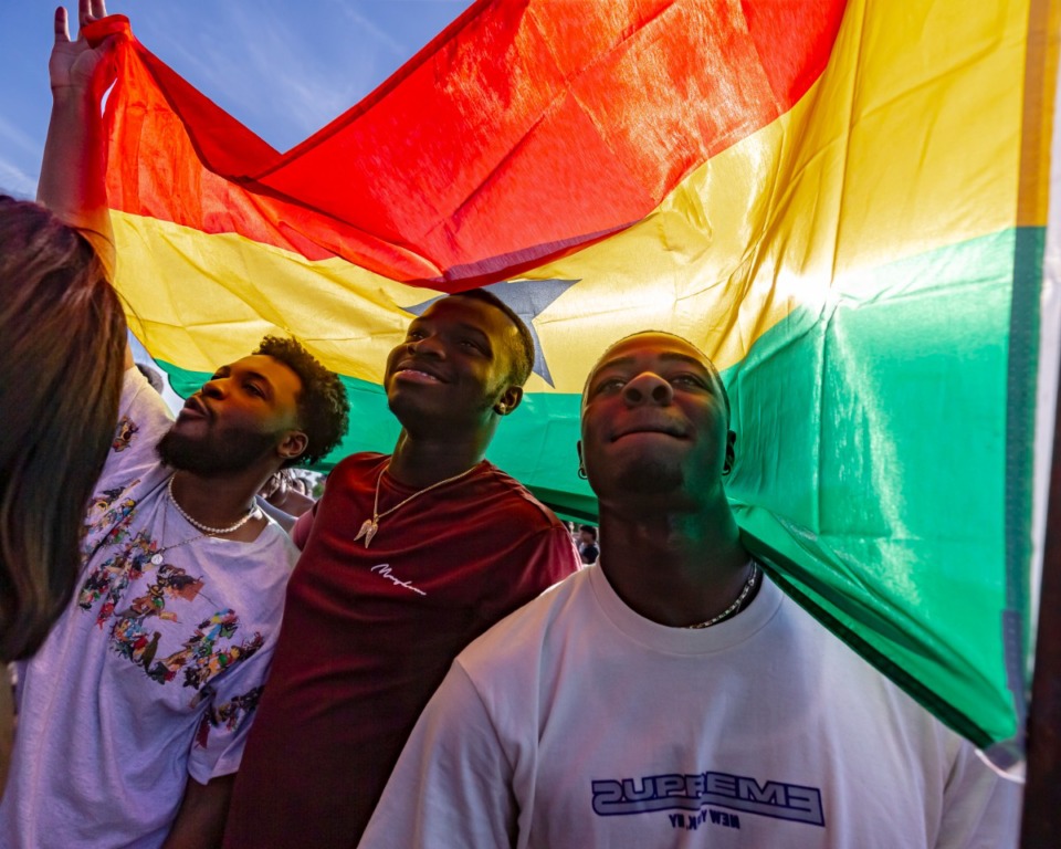 <strong>Ghanian fans of artist Stonebwoy (left to right,) Kofi Assabil, Henry Appiah and Ofori Boateng, enjoy the performance holding Ghana flag at Beale Street Music Festival at the Fairgrounds on Sunday May 1, 2022.</strong> (Ziggy Mack/Special to The Daily Memphian)