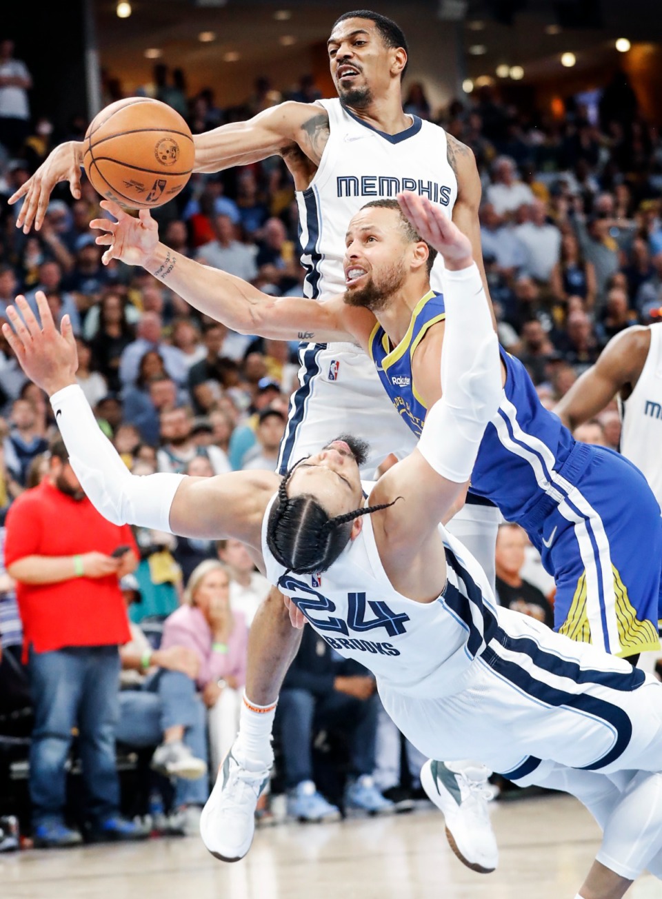 <strong>Memphis Grizzlies&rsquo; De&rsquo;Anthony Melton (top) helps defend as Golden State Warriors guard Steph Curry (middle) is called for a foul after running into Grizzlies defender Dillion Brooks (bottom)&nbsp; during action on Sunday, May 1, 2022 at FedExForum.</strong> (Mark Weber/The Daily Memphian)