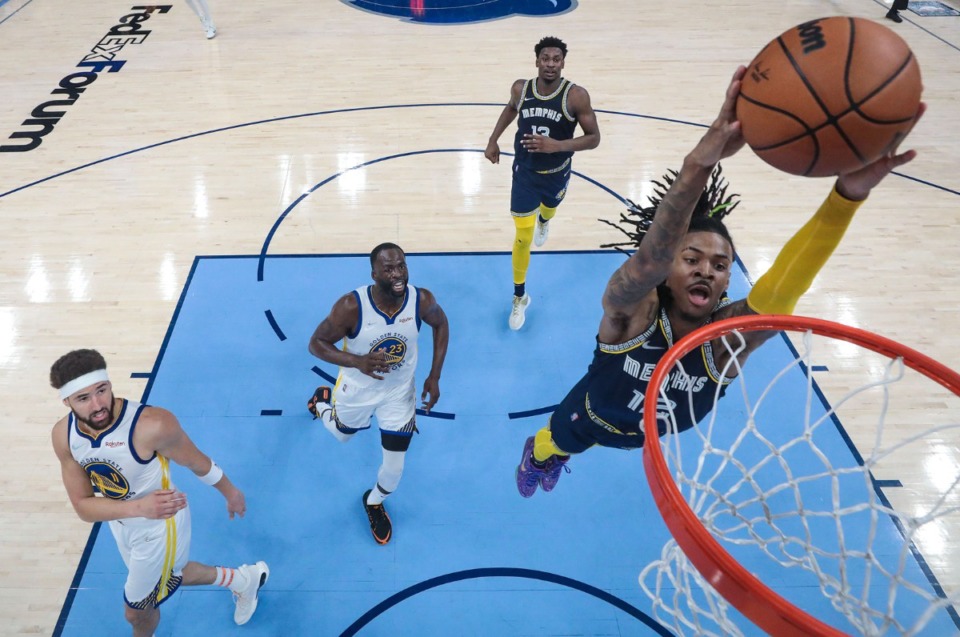 <strong>Memphis Grizzlies guard Ja Morant (12) goes up for a dunk against the Golden State Warriors in Game 2 on May 3.</strong> (Patrick Lantrip/Daily Memphian)