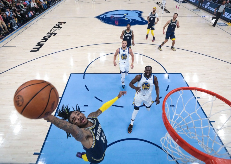 <strong>Memphis Grizzlies guard Ja Morant (12) stretches to catch the ball on May 3 in the playoff game against the Golden State Warriors.</strong> (Patrick Lantrip/Daily Memphian)