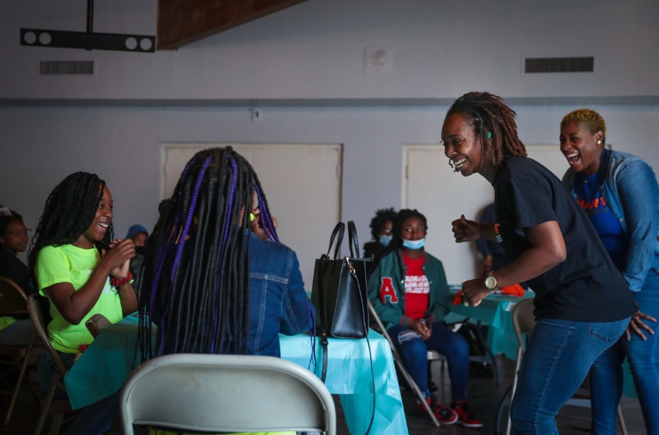 <strong>Nahja Clayton and Kristy Craig (right) talk to a group of kids during the Legacy Impact Resource Community Center&rsquo;s second Youth in Business Workshop in Frayser. </strong>(Patrick Lantrip/Daily Memphian)