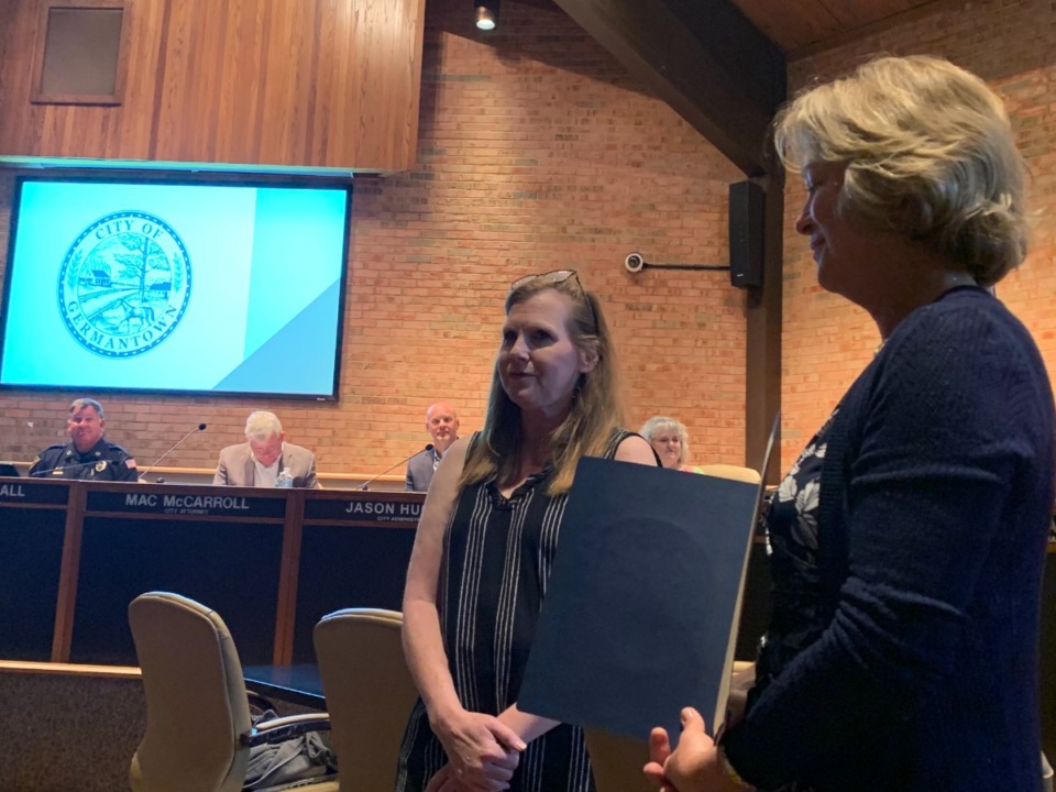 <strong>Robyn Rudisill (left) holds back tears as Alderwoman Sherrie Hicks presents a proclamation honoring Rudisill on Monday, May 9. Rudisill has spent years supporting local education.</strong> (Abigail Warren/The Daily Memphian)